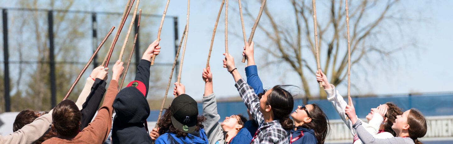 Students holding up sticks at Indigenous Health and Wellness Day